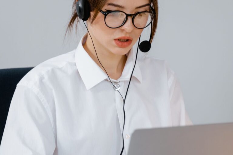 Receptionist with headset answering a call at her laptop