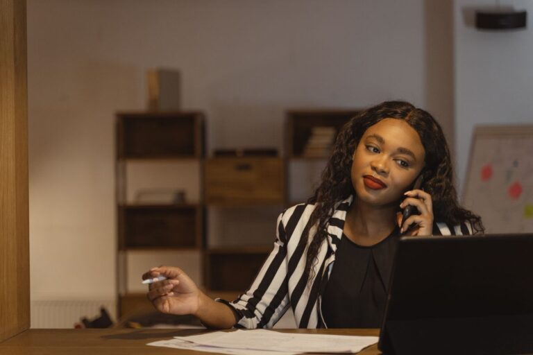 Office professional on the phone with a client at her desk