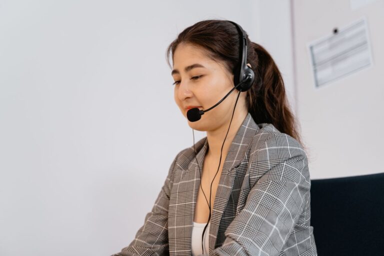 Receptionist with headset speaking warmly with a caller