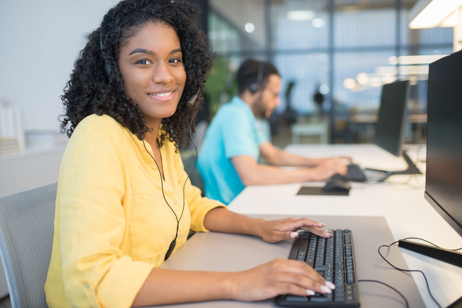 Smiling receptionist at her desk ready to help callers